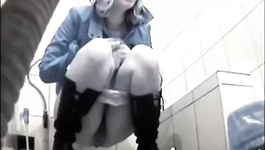 Girl in black boots scat squatting