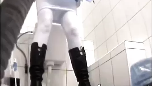 Girl in black boots scat squatting